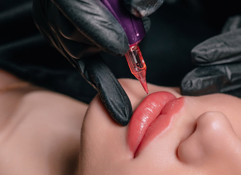 Lip tattoo in progress showing professional cosmetic tattooing technique for natural lip colour enhancement